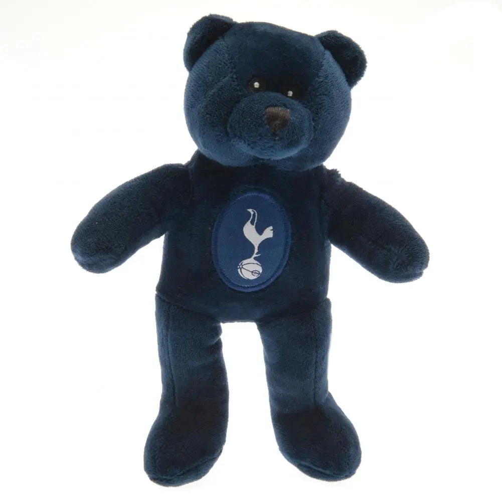 A plush toy teddy bear in navy blue with the Tottenham Hotspur club crest on the front.