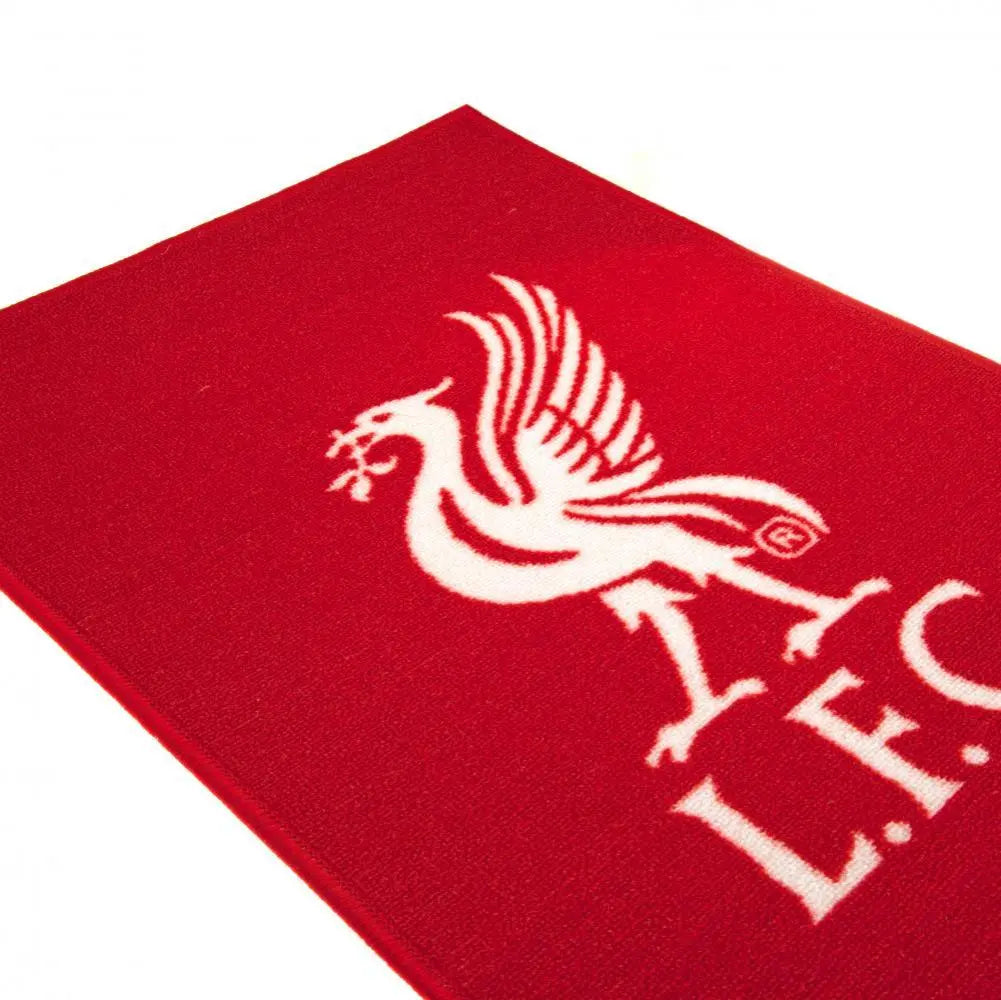 A red rectangular rug with the white Liverpool FC team crest printed in the center.