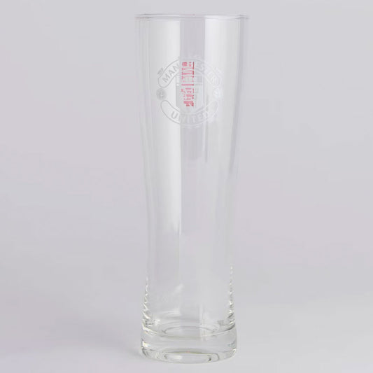 Clear Manchester United glass with embossed design on a light gray background