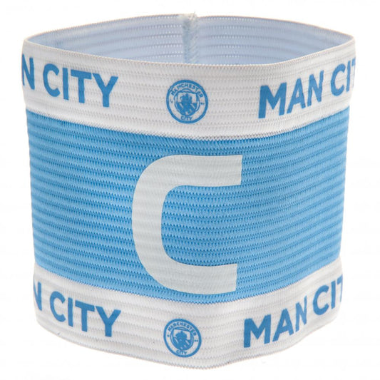 Light blue and white captains armband with Manchester City logo and text on a white background