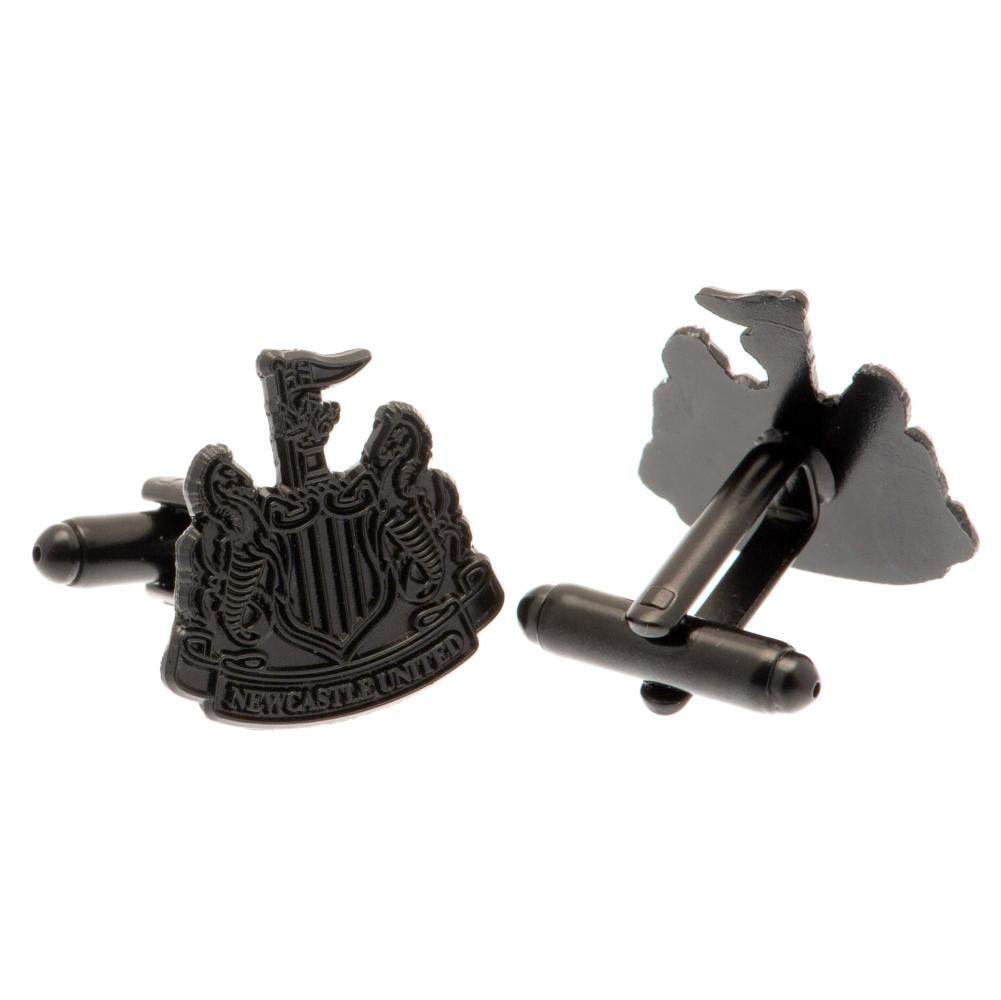 A pair of black cufflinks featuring the Newcastle United football club crest on one side and the club's map outline on the other, shown against a plain white background.