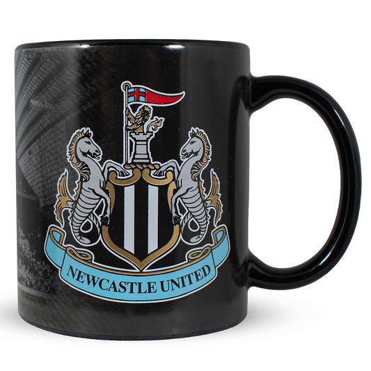 A glossy black ceramic mug featuring the Newcastle United football club crest, including two white horses, a black and white shield, a red flag, and a light blue banner reading 'NEWCASTLE UNITED'.