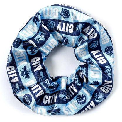 Blue and white Manchester City patterned scrunchie with 'City' text on a white background