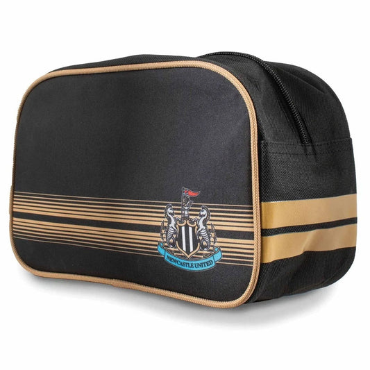 A black nylon toiletry bag with gold trim, featuring the Newcastle United football club crest and gold horizontal stripes on the front, set against a plain white background.