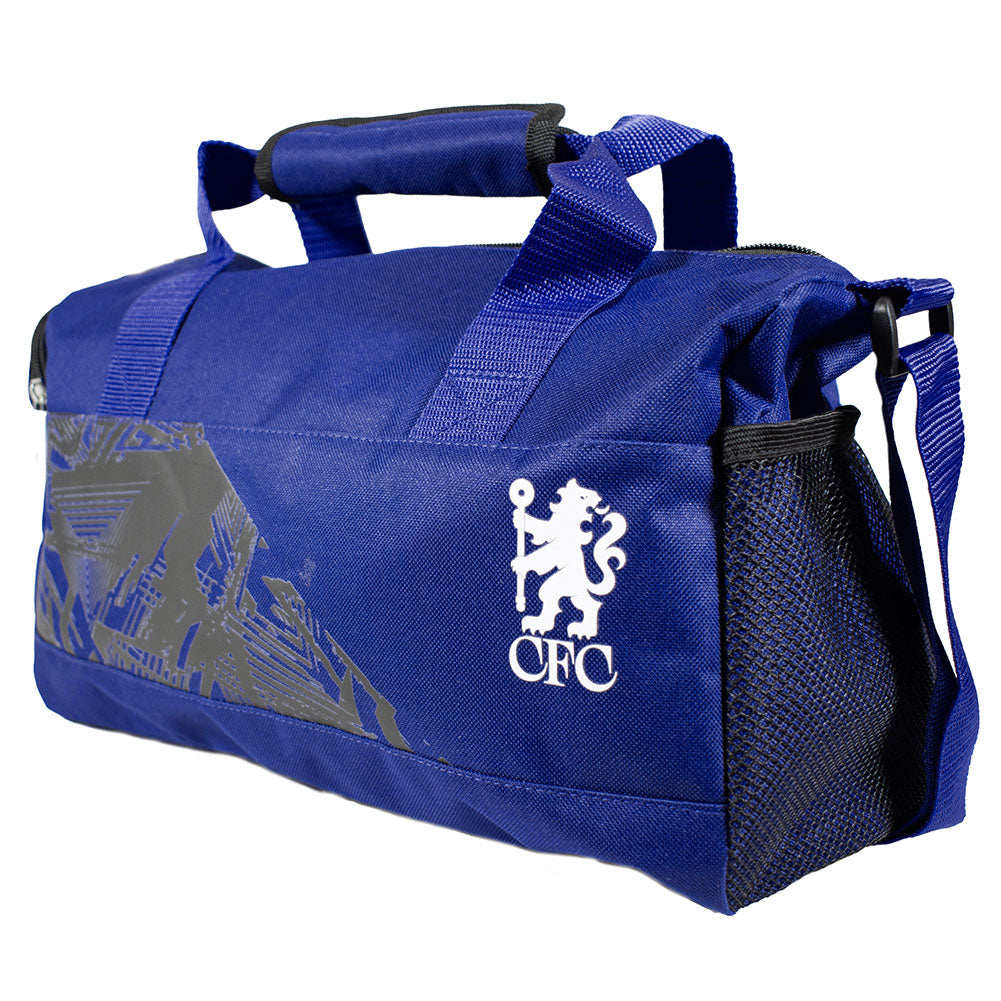 A royal blue Chelsea Football Club duffel bag with a white CFC lion crest logo on the front, a gray graphic pattern on the side, and a black mesh side pocket, shown on a white background.