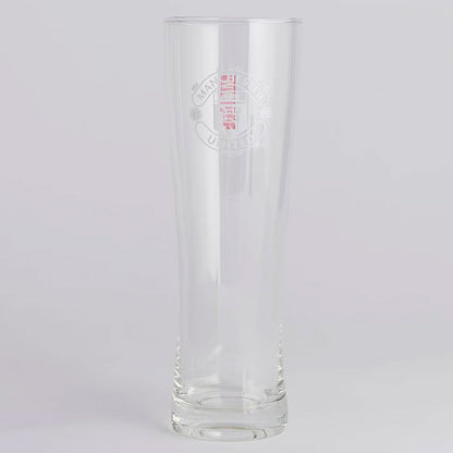 Clear Manchester United glass with embossed design on a light gray background