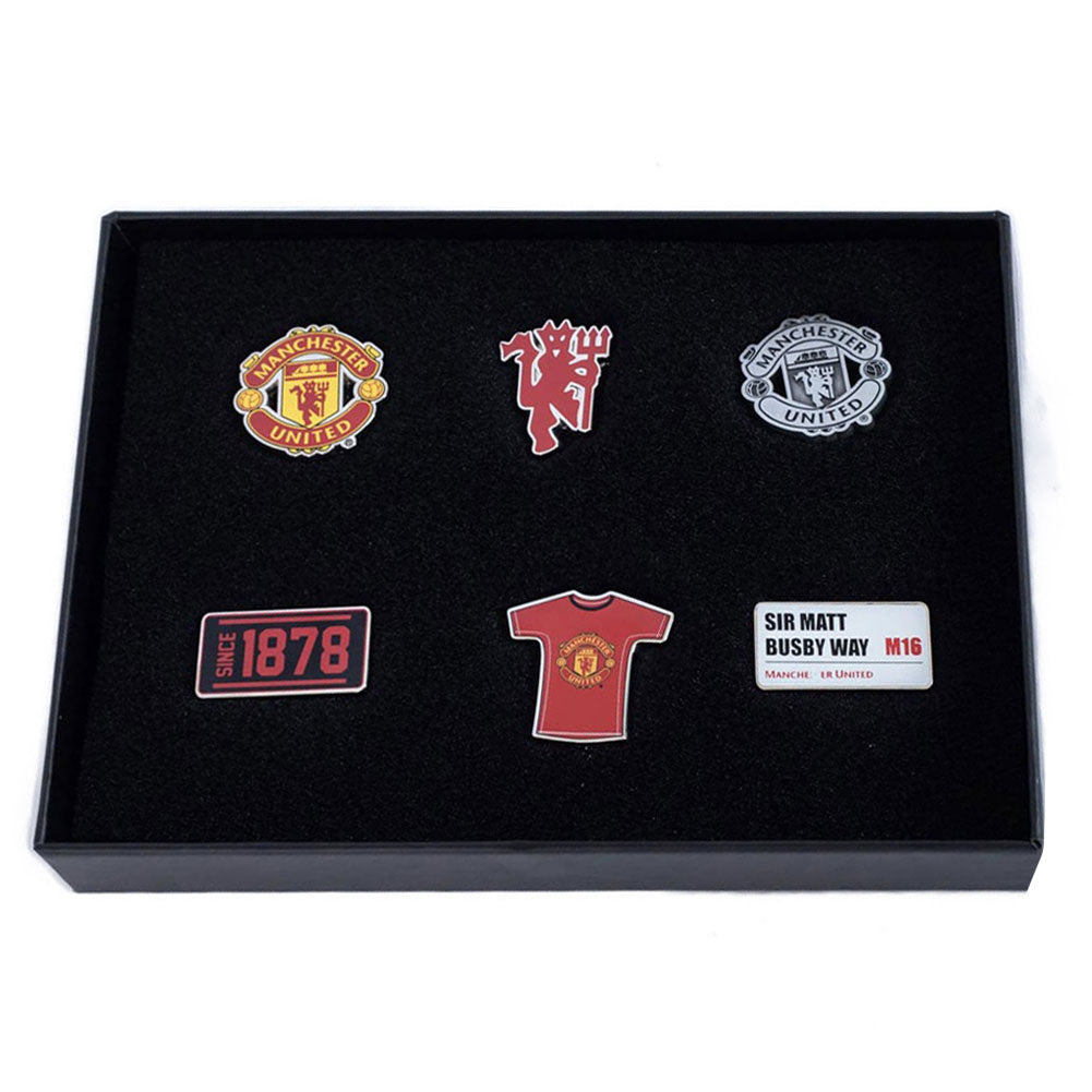 Set of Manchester United-themed pins in a black display box