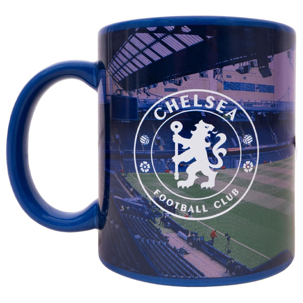 A blue ceramic Chelsea Football Club mug featuring a printed stadium scene with the club's lion crest in white on the front, shown on a plain white background.