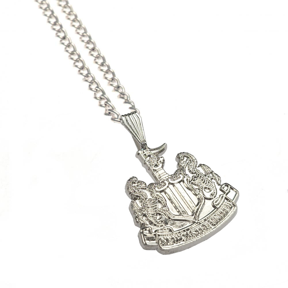 A silver-toned metal pendant necklace featuring a detailed crest or shield design with a central sword and surrounding decorative elements, suspended from a curb chain on a plain white background.